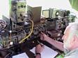 Dave Benson, K1SWL, operates one of HQ-Coy's three, 1943-original, Wireless Sets No. 19. The vibrator and dynamotor power-supply in the module at far left drew 4 A (receiving) to 10 A (transmitting, CW, key down) at 12 VDC from storage batteries under the table. An original WW II gasoline-powered generator recharged these batteries. The 19 Set transmits 10 W on CW and its receiver bandwidth is 9 kHz -- so copy was difficult under the crowded Field-Day band conditions. Nevertheless, confirmed FD exchanges were completed with 60 stations on 40 and 80 meters. (Click on photo to enlarge.)